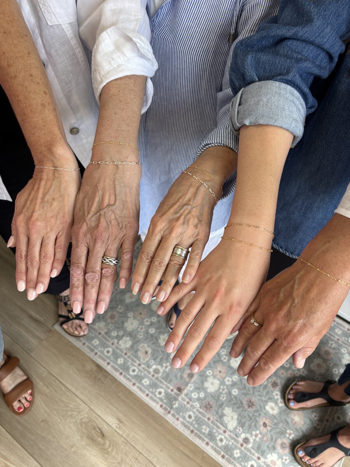 Client wearing a delicate permanent jewelry stack