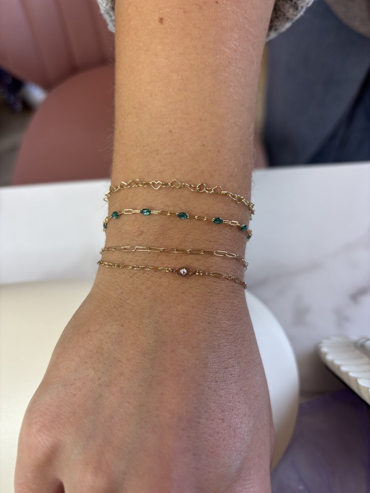 Client wearing layered permanent bracelets