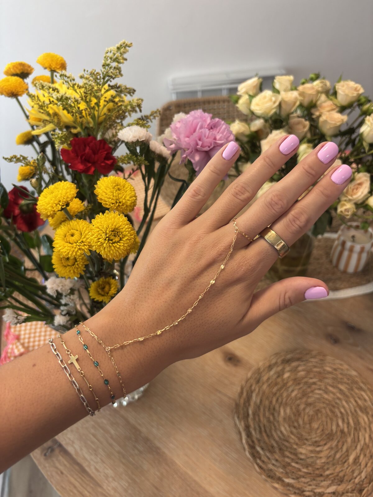 Delicate gold and silver bracelets with a hand chain